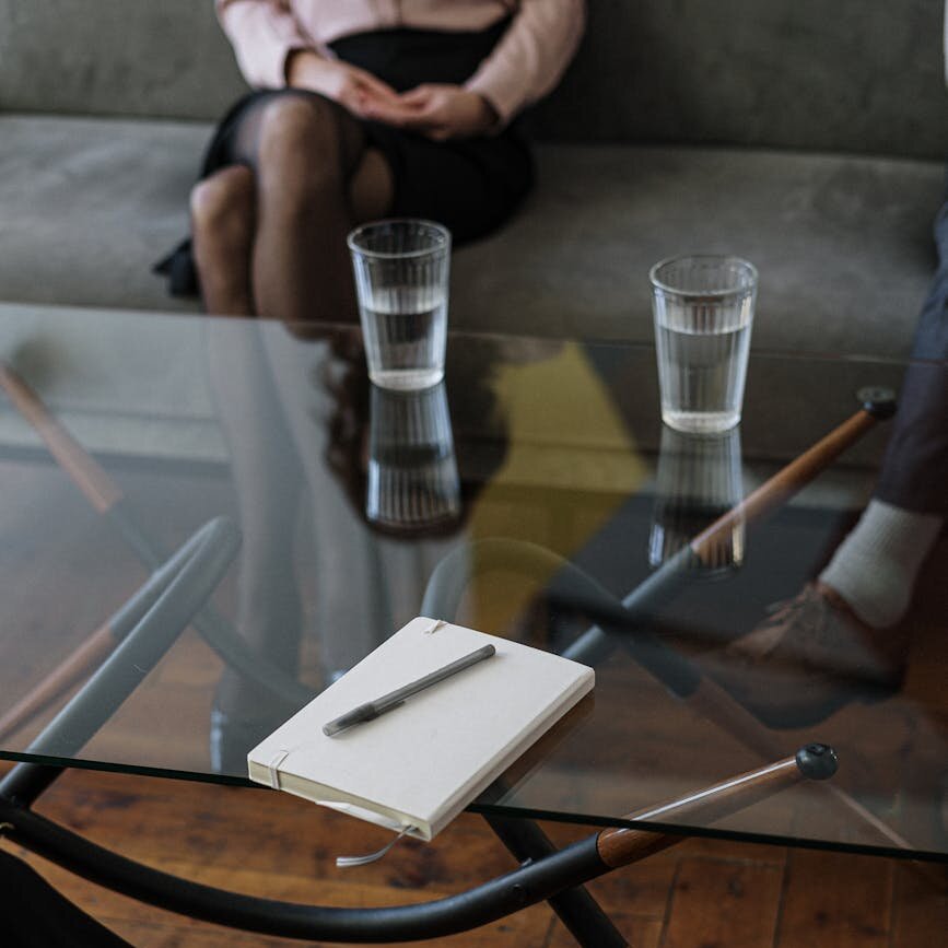 white and silver chair beside clear drinking glass on glass table